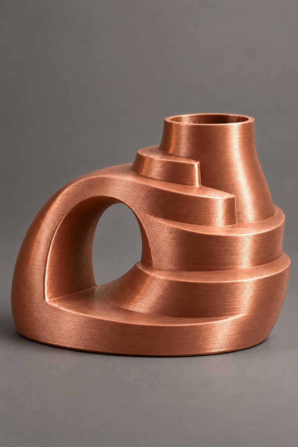 Terrace Arc vase concept with spiraling stepped terraces with an off-center chamber and side arch, front view, in the Silk Coffee Gold color direction. AI visualization.