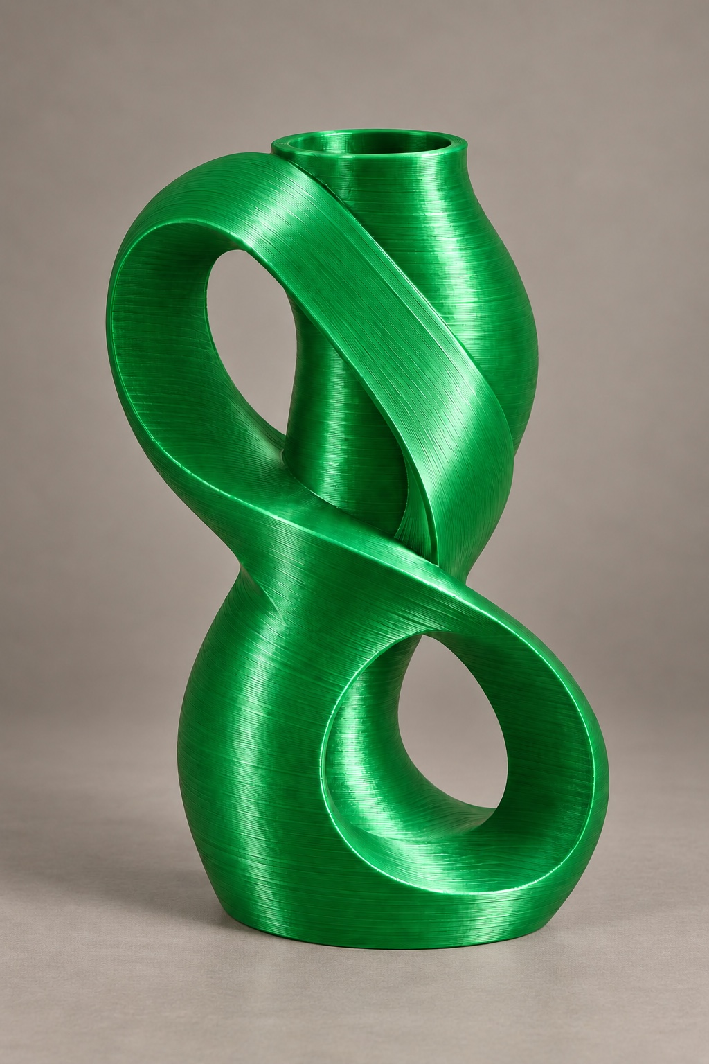 Infinity Coil vase concept with an offset infinity-shaped ribbon framing two curved windows, front view, in the Silk Christmas Green color direction. AI visualization.